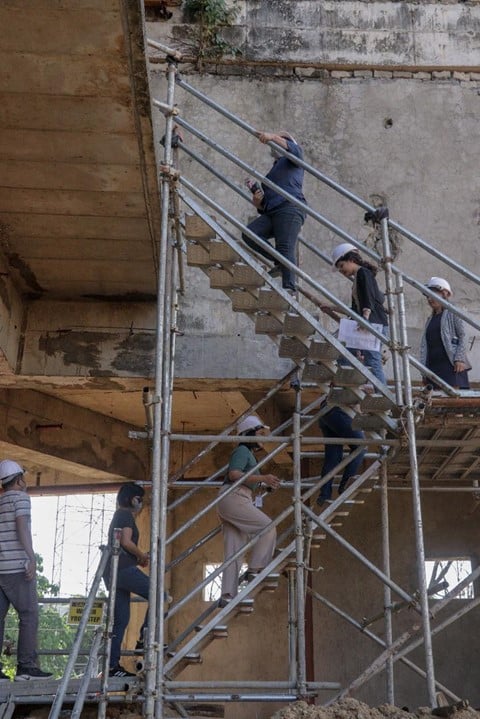 PMEs climbing up to inspect the Education and Student Center Building