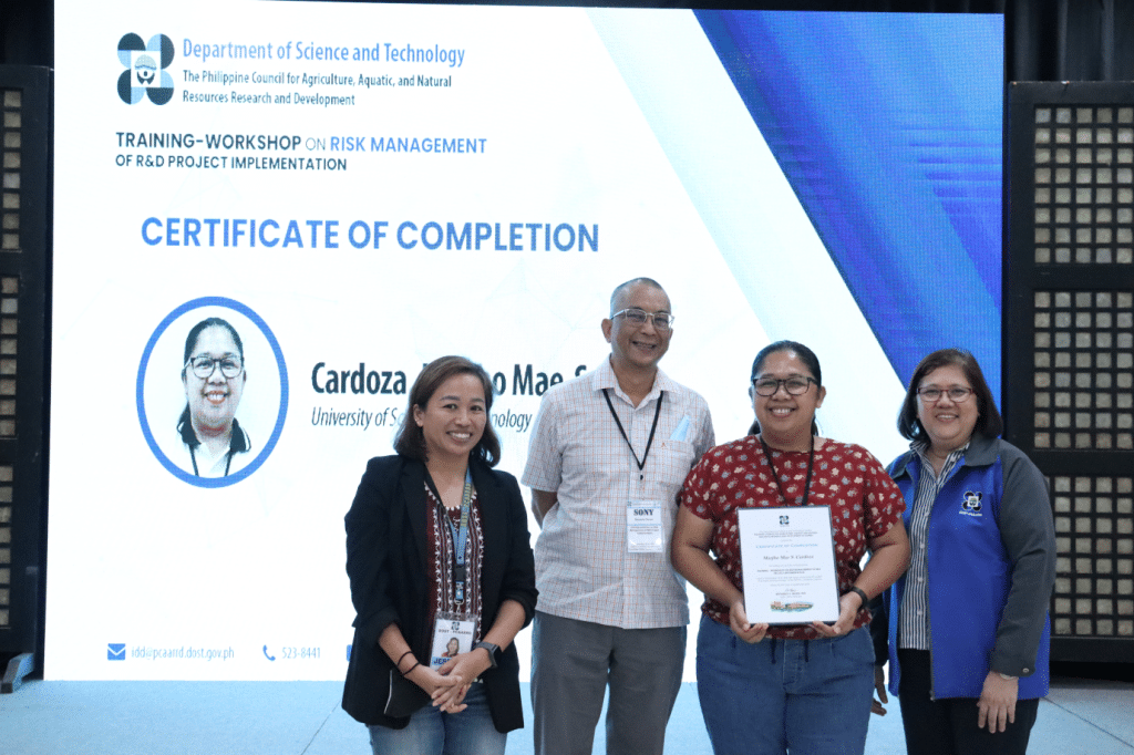 Ms. Marjho Mae S. Cardoza receives her certificate of completion